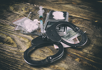 Illegal Drugs, Money and Handcuffs