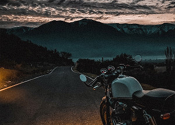 Motorcycle on a mountain road at dusk