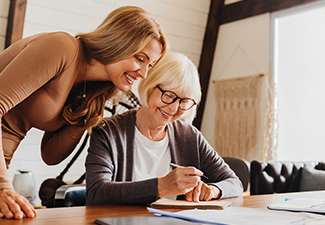 Investment advisor consulting with retired woman at home.