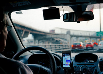 Man driving car with GPS on phone