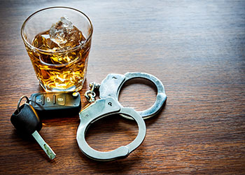 Whiskey with car keys and handcuffs