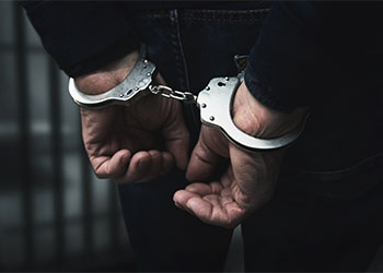 arrested man with cuffed hands 