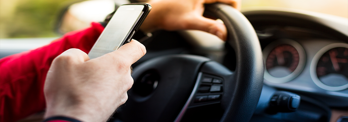 Man driving car while texting