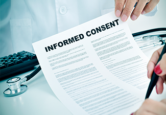 Woman signing an informed consent form