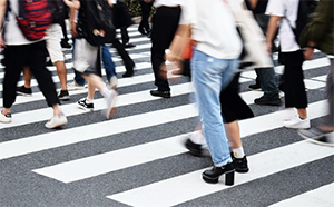 Group of people walking on a crosswalk in the street