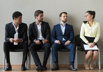 Four people sitting on a bench