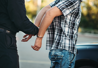 Policeman Arrests a Person on Road