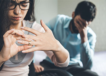 Angry woman removing ring from hand