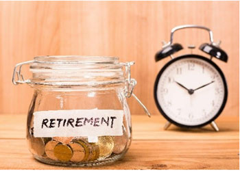 Jar of coins labeled "Retirement" next to a clock