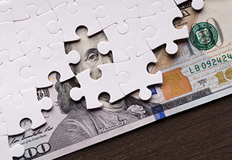 American Dollar Hidden Under Puzzle Pieces