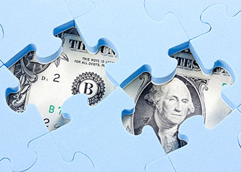 American dollar hidden under puzzle pieces