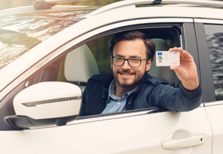 Young Happy Man Showing His New Driver License