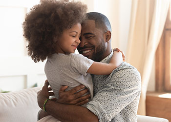 Happy  father embracing cute little  daughter