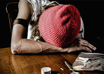 Teen heroin user lying on table