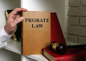 Lawyer takes a book Probate law from a shelf