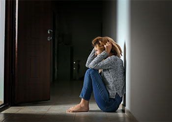 Woman having panic attack indoors