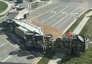 Truck accident skidded and flipped over.