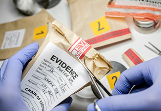 Scientific Police Opens with Scissors a Bag of Evidence of A Crime