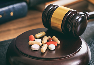 Judge Gavel and Drugs on A Wooden Desk