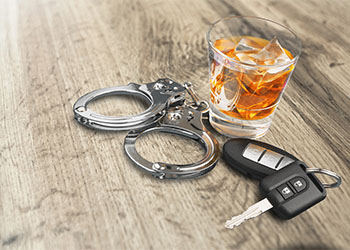 Whiskey with car keys and handcuffs