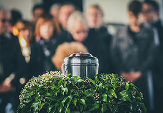 A Metal Urn with Ashes of A Dead Person on A Funeral