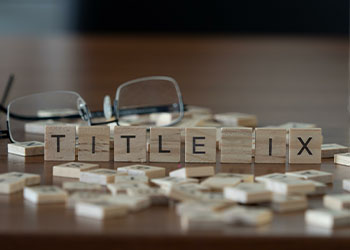 Title IX word represented by wooden letter tiles