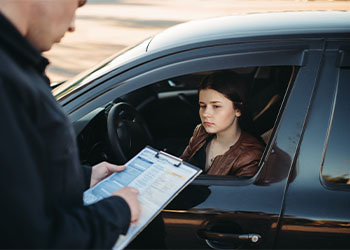 Policeman in uniform writes fine to female driver