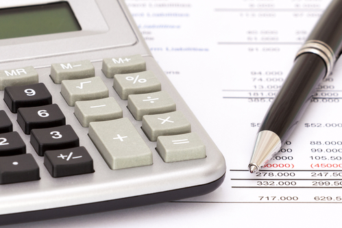 A calculator on top on some financial documents.