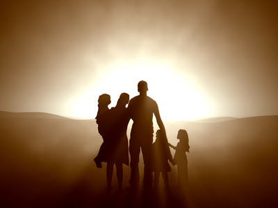 A family's silhouette at sunset.