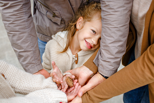 A family holding a shell together.