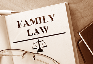 Book with words family law and glasses.