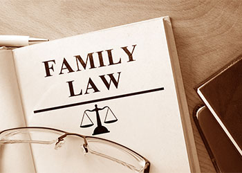 Book with words family law and glasses