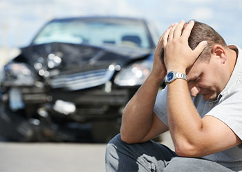 Upset man after car crash