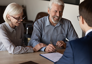  Family couple of clients consulting lawyer about trust document