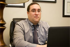 Josh sitting at his desk