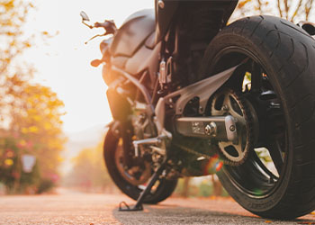 Motorcycle parked on the road in warm light