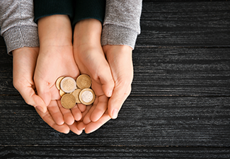 Hands of Woman and His Son Holding Coins on Wooden Table