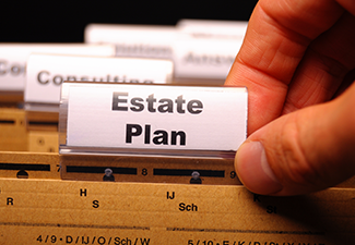 Man Holding a Card with Text "estate Plan"