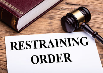 Restraining Order Text on Sheet next to a Gavel