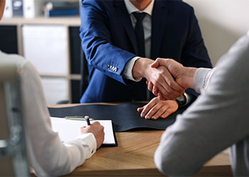 Male lawyer working with clients in office