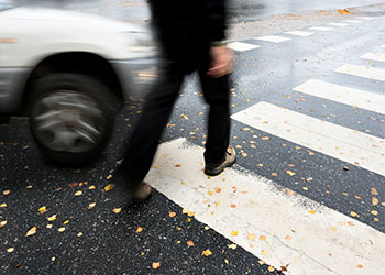 Car about to hit a pedestrian at zebra crossing