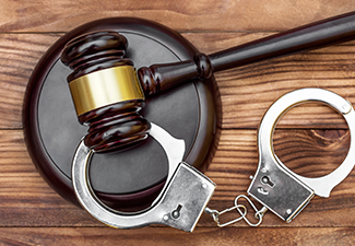 Gavel with Stand and Handcuffs on The Wooden Background