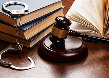 Gavel, books and handcuffs