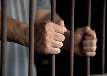 Hands of the prisoner in jail