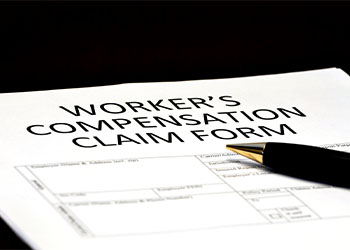 Worker's Compensation claim form and pen