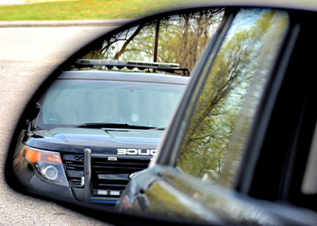 Police car has a motorist stopped for a violation