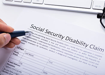 Person Filling Social Security Disability Claim Form