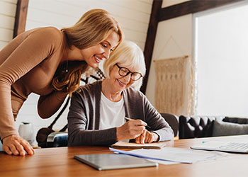 Old woman with daughter review estate plan document