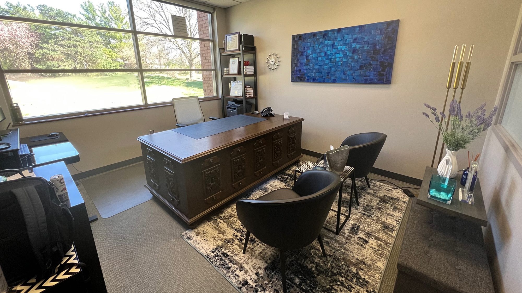 An office with a desk and chairs.