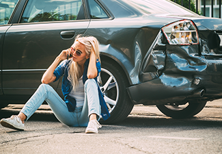 Girl Sits on The Road, Near the Broken Car